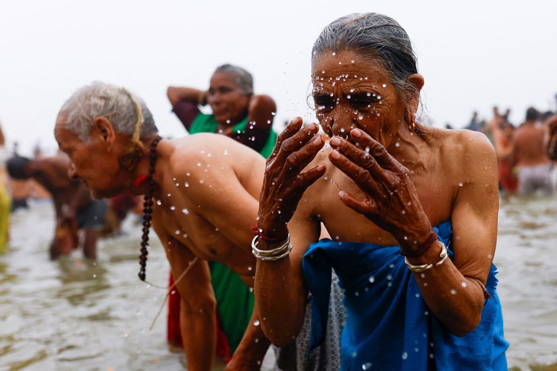 Devotees take a holy dip during the Maha Kumbh Mela in Prayagraj, India, January 13, 2025.