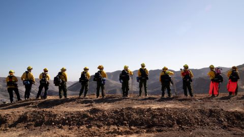 Firefighters from Mexico rest while hiking to their destination to cut a containment line in the Tarzana area during the Palisades Fire in Los Angeles, California, U.S. January 13, 2025. REUTERS/David Ryder     TPX IMAGES OF THE DAY     