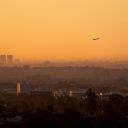 A plane takes off amidst smoke from the Palisades Fire in Los Angeles, California, U.S. January 14, 2025. REUTERS/David Ryder