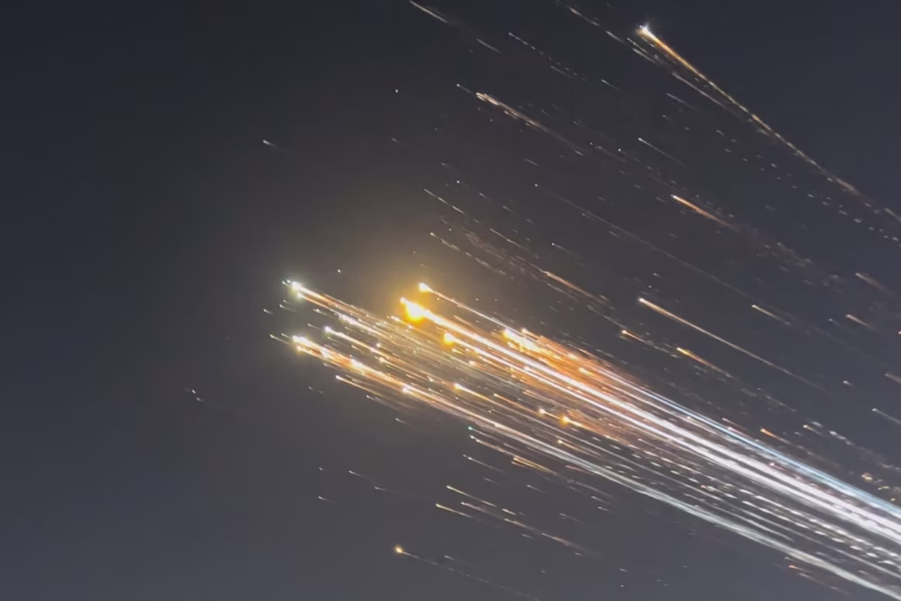 Orange balls of light fly across the sky as debris from a SpaceX rocket launched in Texas is spotted over Turks and Caicos Islands on January 16.