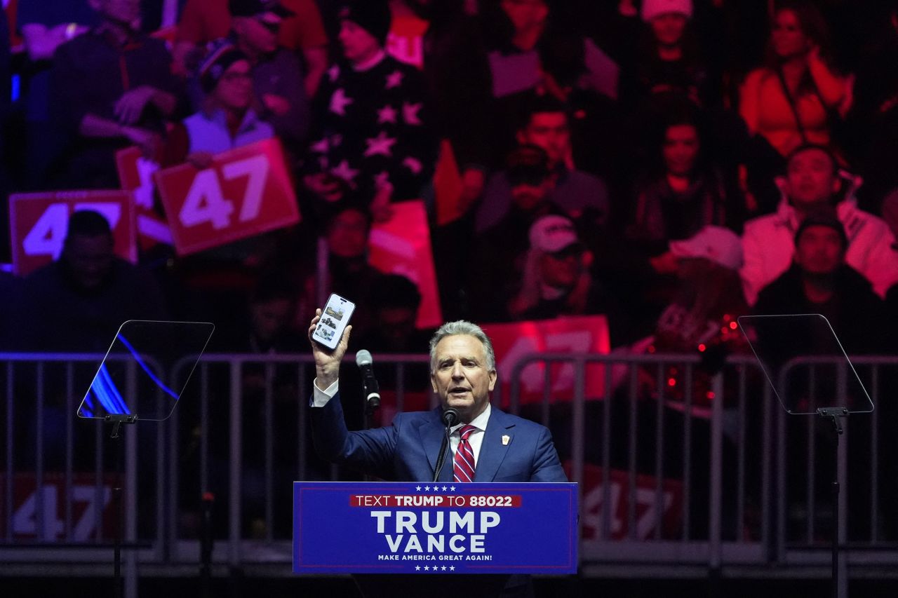 Steve Witkoff shows his phone during a rally for President-elect Donald Trump in Washington, DC, on Sunday.