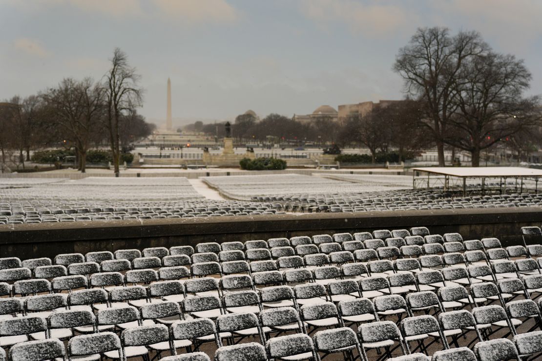 A dusting of snow blankets the National Mall on the eve of the 2025 presidential inauguration, which will take place indoors due to inclement weather.