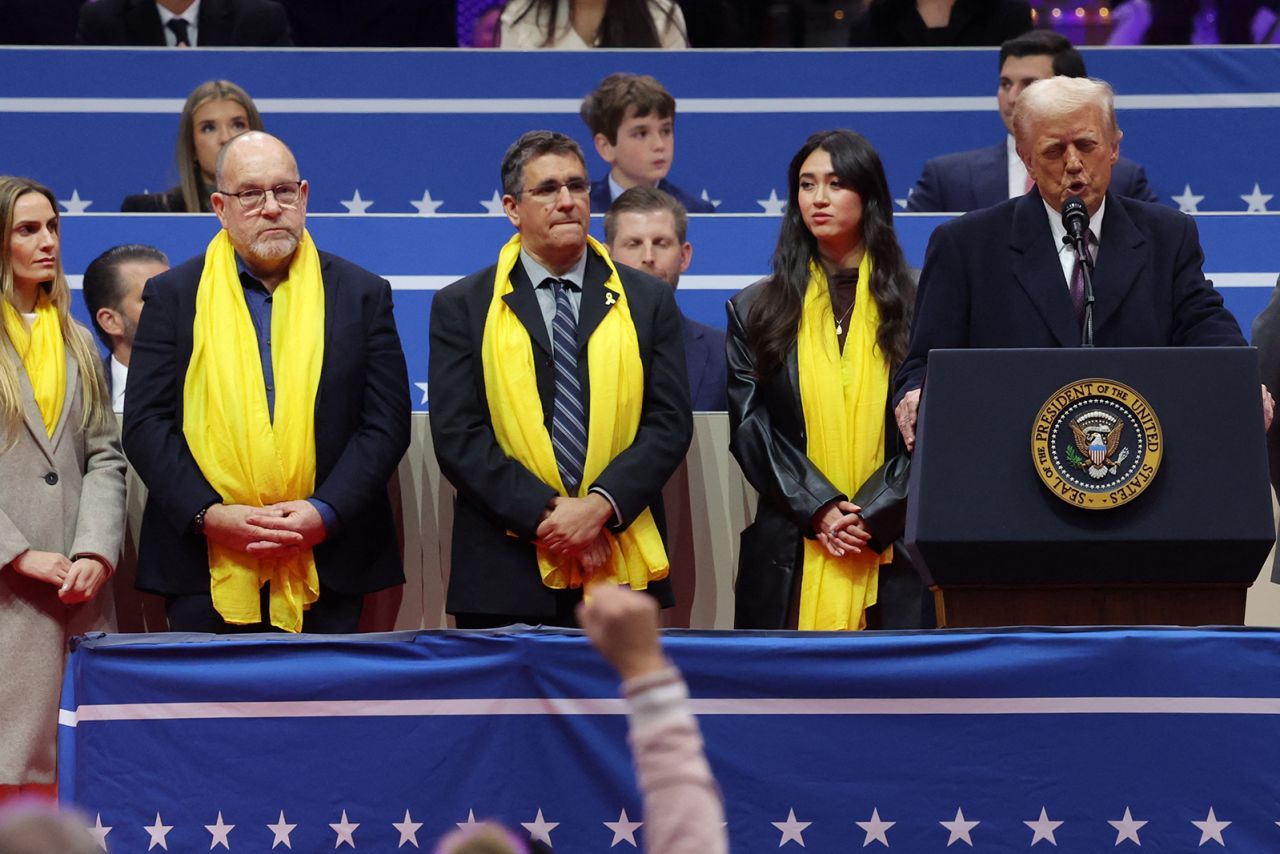 US President Donald Trump speaks as relatives of Israeli hostages look on in the Capital One Arena during ceremonies on the inauguration day of his second presidential term.