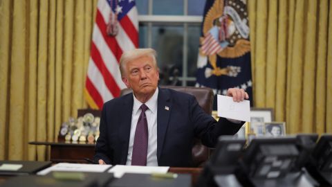 President Donald Trump holds a letter from former United States President Joe Biden in the Oval Office on Inauguration Day in Washington, on January 20, 2025.
