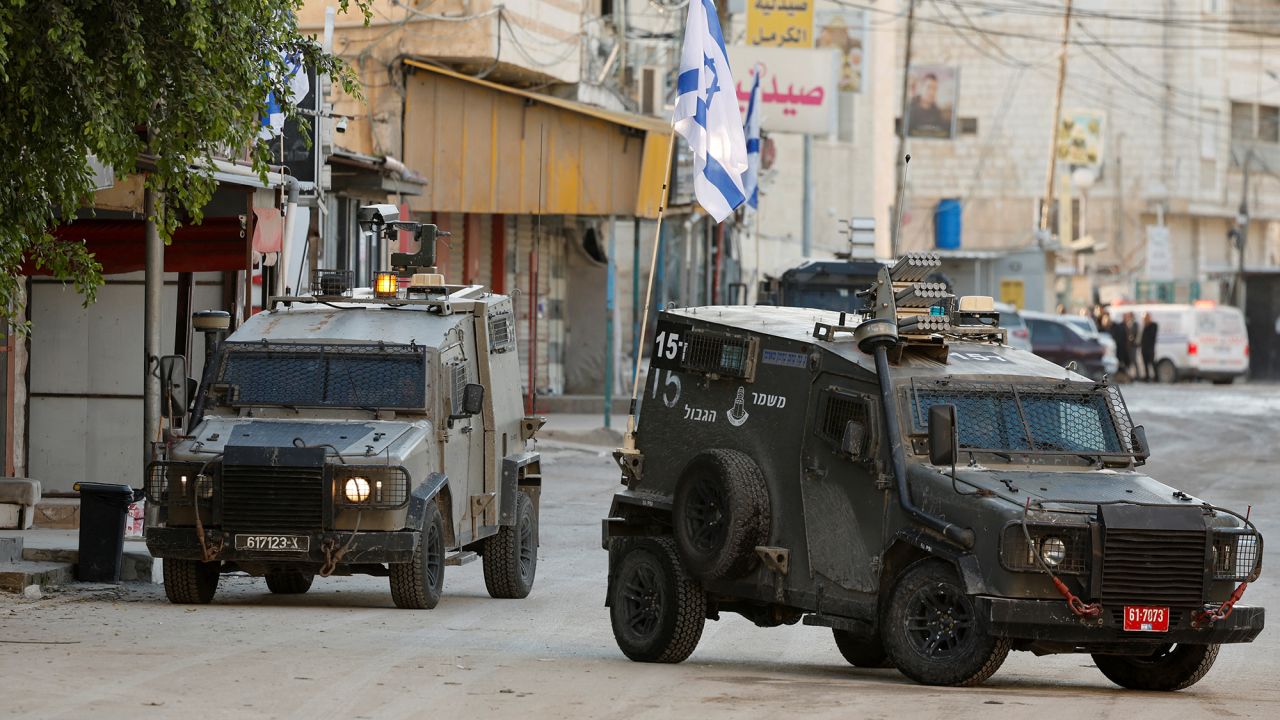 Israeli military vehicles drive on the street during an Israeli raid in Jenin, in the Israeli-occupied West Bank, January 21, 2025. REUTERS/Raneen Sawafta