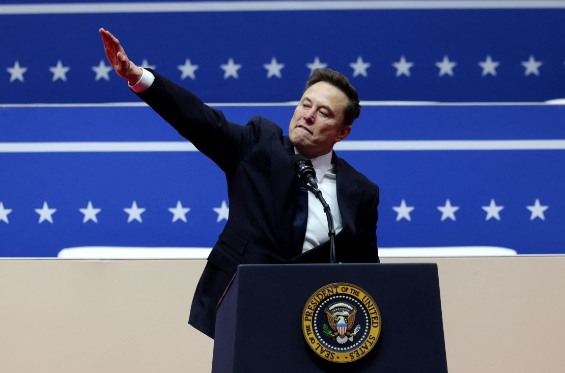 Elon Musk gestures at Capital One arena during President Donald Trump's inauguration in Washington, DC, on January 20, 2025. He has denied the straight-armed salute was a Nazi gesture.