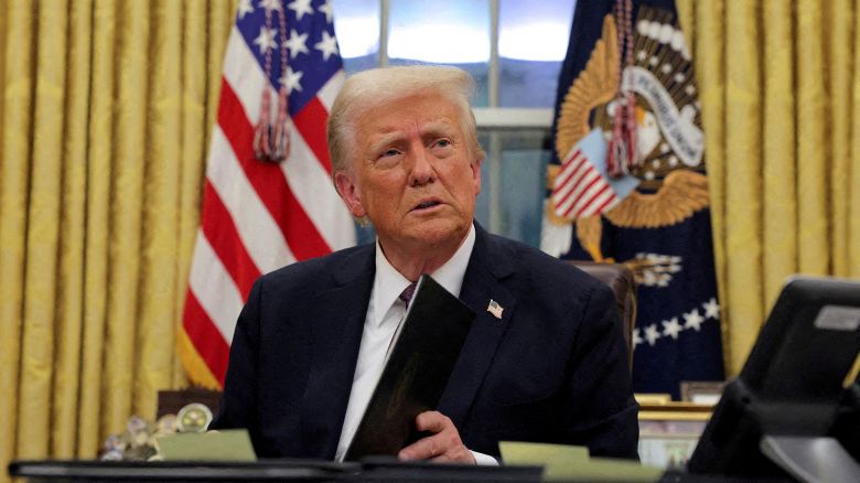 President Donald Trump signs documents as he issues executive orders and pardons in the Oval Office at the White House on Inauguration Day in Washington, U.S., January 20, 2025.