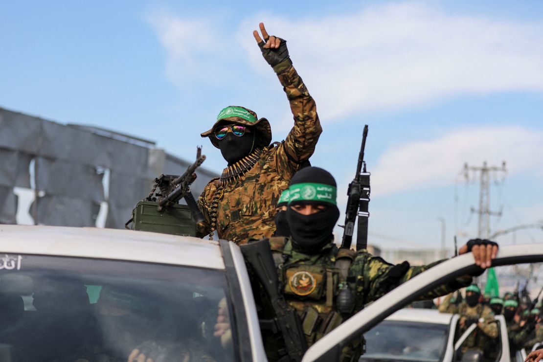 Palestinian Hamas militants parade before the handover of four female hostages in Gaza City on Saturday.