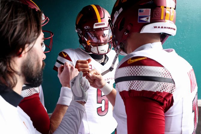 Washington Commanders quarterback Jayden Daniels huddles with teammates before the game against the Philadelphia Eagles in Philadelphia on January 26.