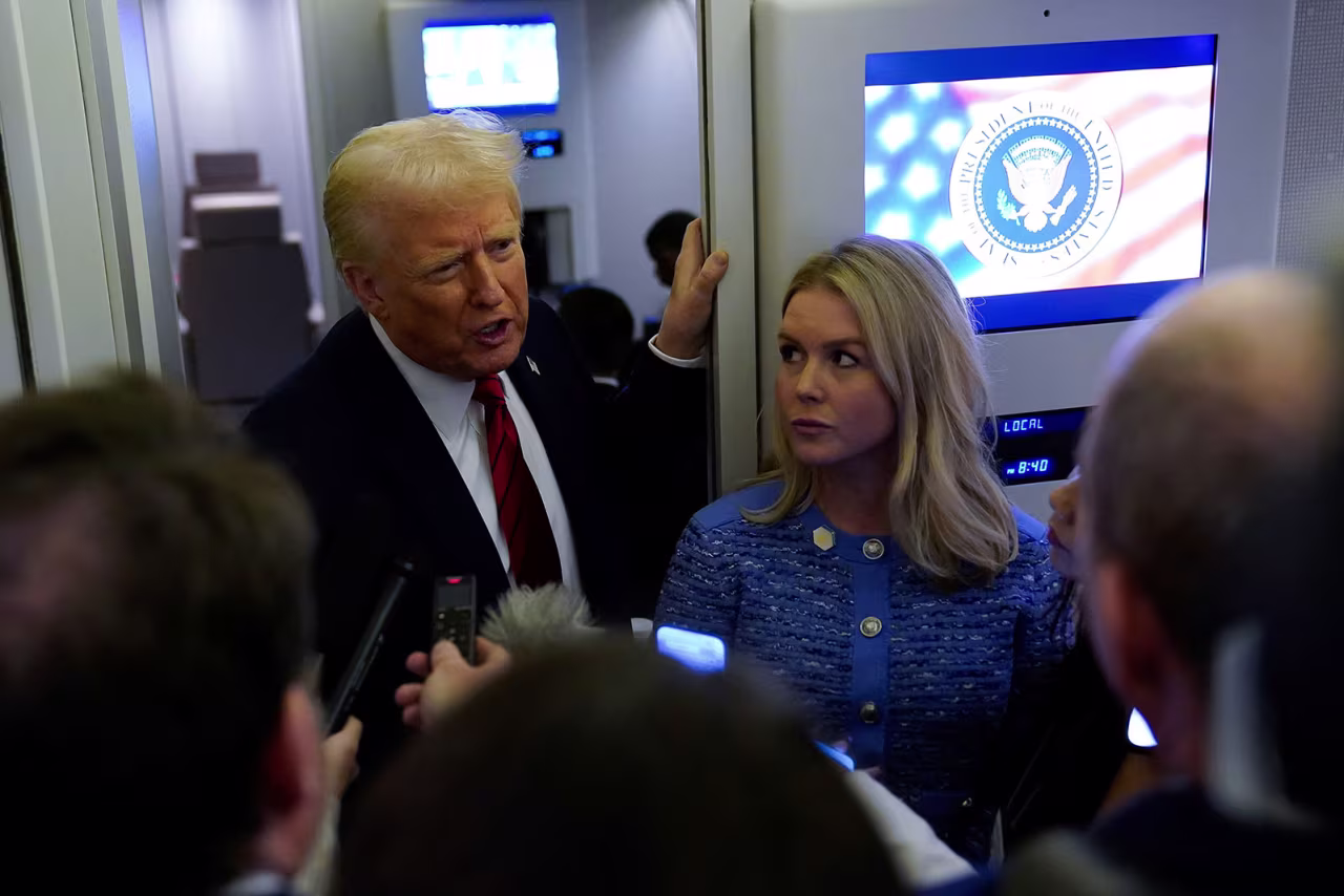 President Donald Trump speaks to reporters with White House Press Secretary Karoline Leavitt aboard Air Force One before arriving at Joint Base Andrews, Maryland, on Monday.