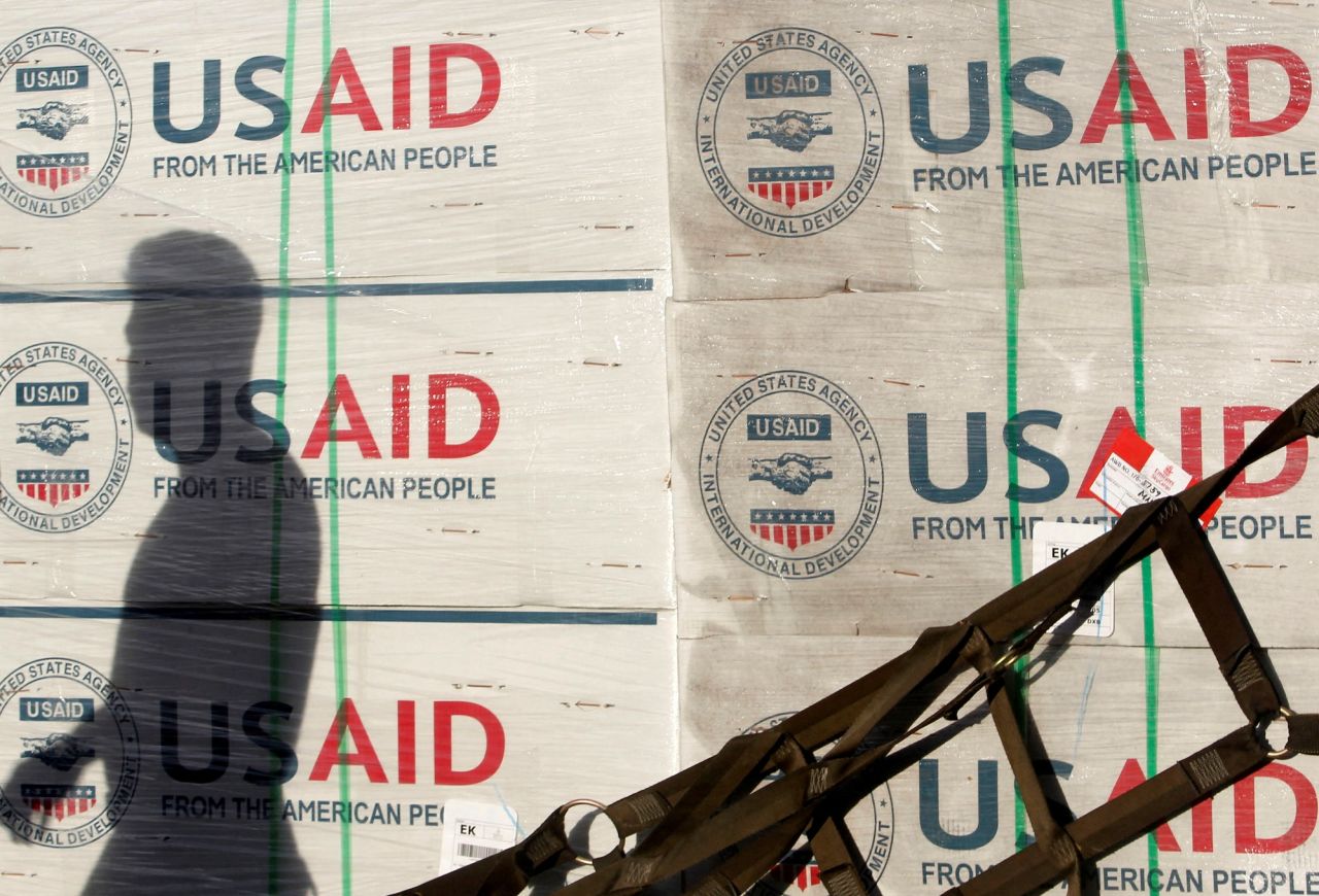 The shadow of a Philippine Army personnel is cast on boxes of relief items from USAID for the victims of super typhoon Haiyan, at Villamor Air Base in Manila on November 13, 2013.