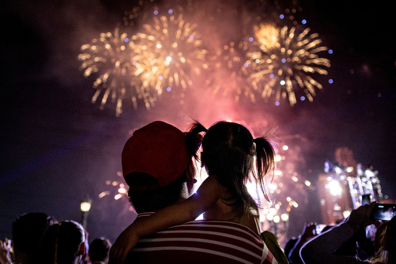 A man and a young child watch fireworks during Lunar New Year celebrations in Manila, Philippines, on Wednesday.