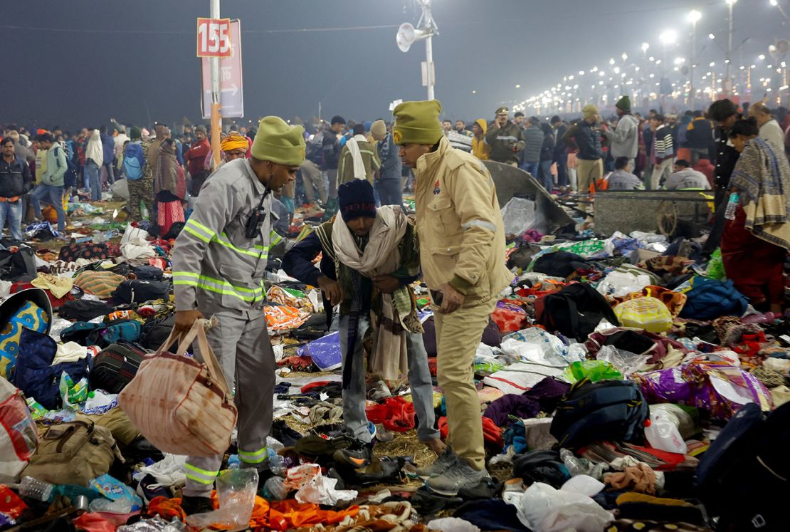 Security personnel assist a person after a crowd crush at the Kumbh Mela in Prayagraj, India, on January 29, 2025.