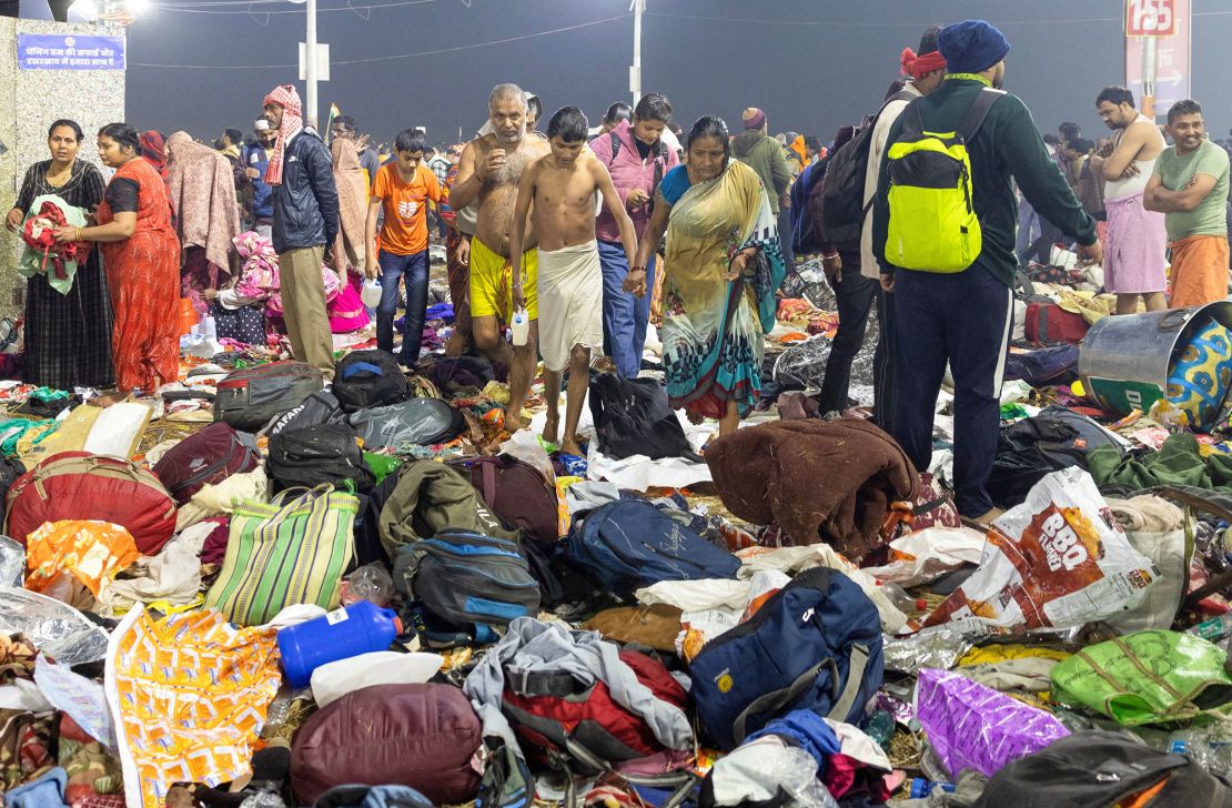 Devotees, after taking a holy dip, walk past the belongings of people caught up in a crowd crush at the Maha Kumbh Mela in Prayagraj, India on January 29, 2025.