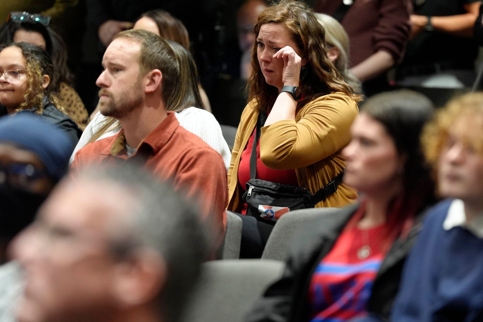 Jessica DeVader wipes away a tear during the prayer vigil in Wichita on Thursday.