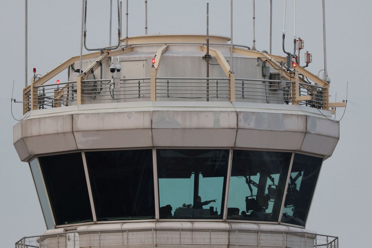 People work inside air traffic control at Reagan National Airport on Thursday.