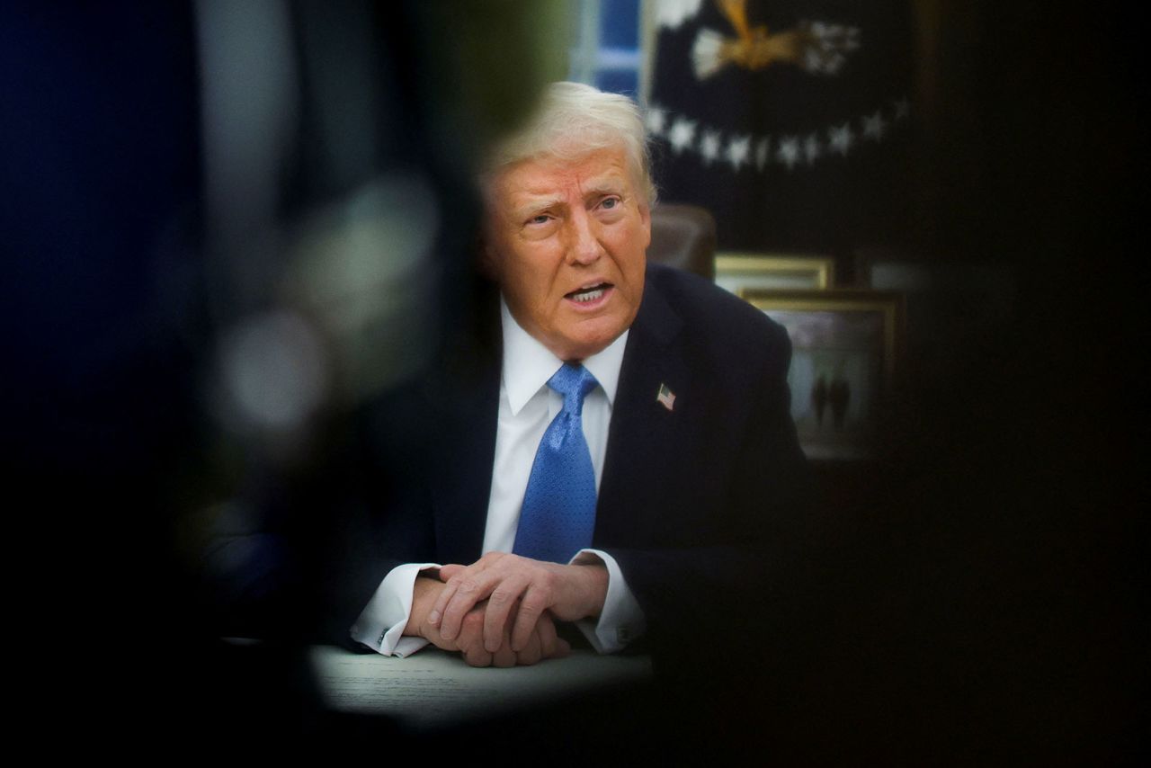 President Donald Trump speaks as he signs an executive order in the Oval Office at the White House in Washington, DC, on Friday.