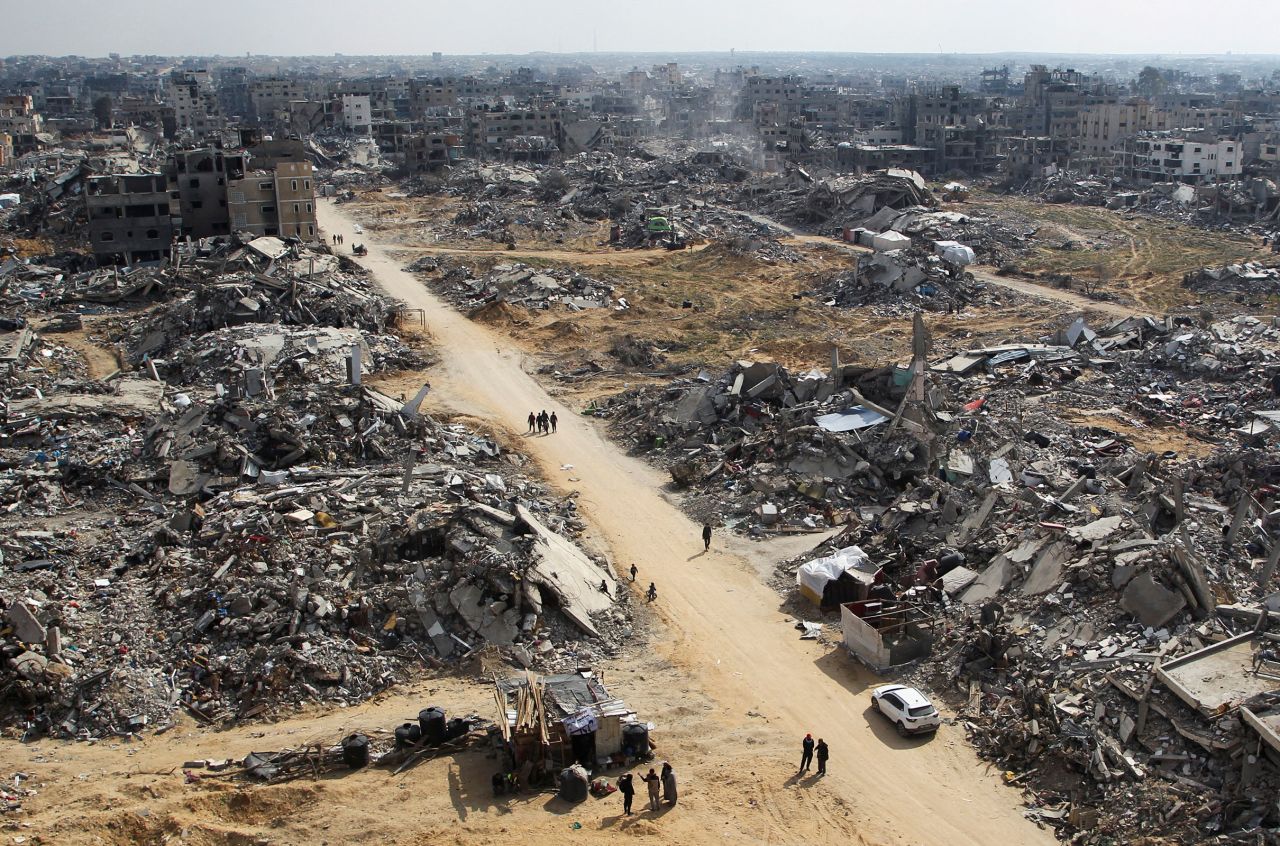 Palestinians walk past the rubble of buildings destroyed during the Israeli offensive in Rafah, Gaza, on February 4.