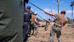 U.S. Navy sailors and Coast Guardsmen erect expeditionary shelter tents in support of the expansion of migrant detention at Naval Station Guantanamo Bay, Cuba, February 2, 2025.