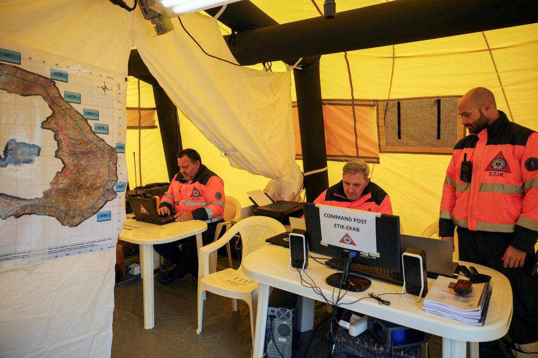 Emergency personnel work at the temporary headquarters of emergency services on the island of Santorini.