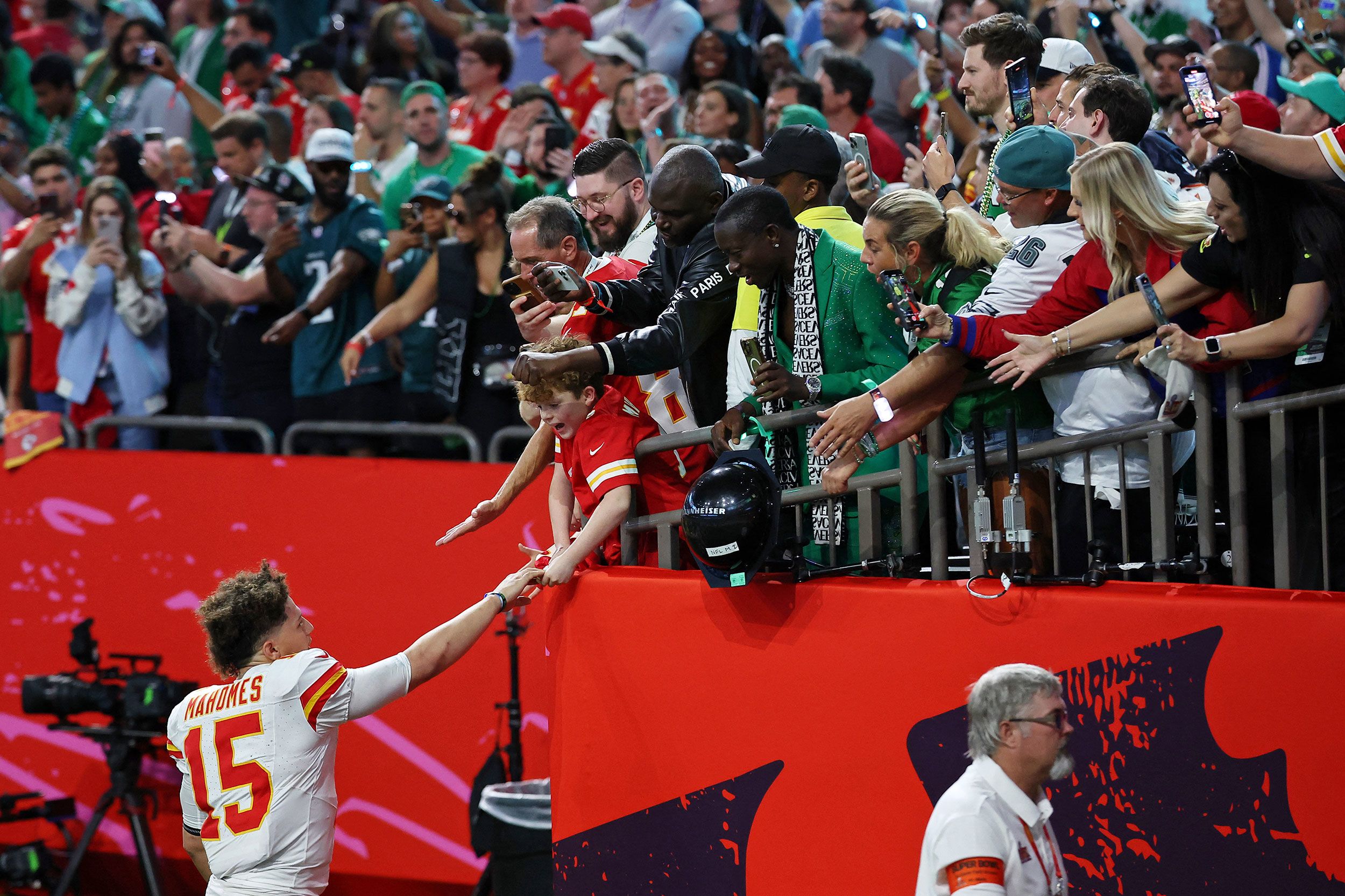 Kansas City Chiefs quarterback Patrick Mahomes greets fans as he walks off the field after the game.