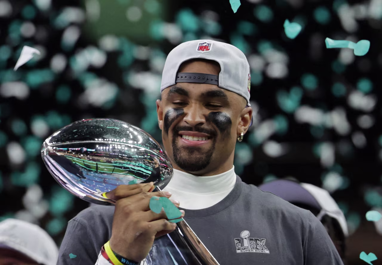 Philadelphia Eagles quarterback Jalen Hurts celebrates with the Vince Lombardi Trophy.