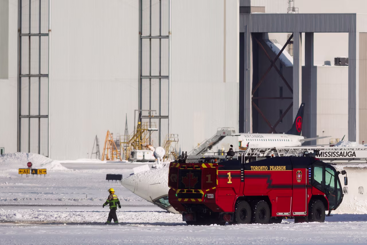 An emergency responder works near the plane.