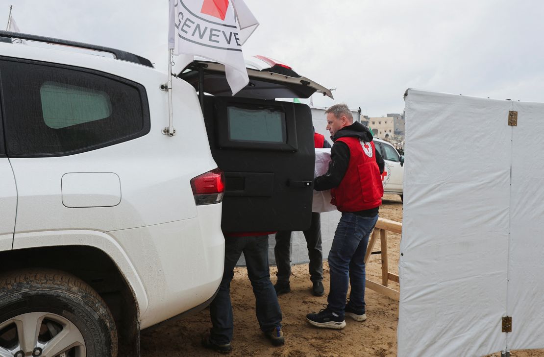 Members of the Red Cross move a casket during the handover of deceased hostages in Khan Younis, Gaza, on February 20, 2025.