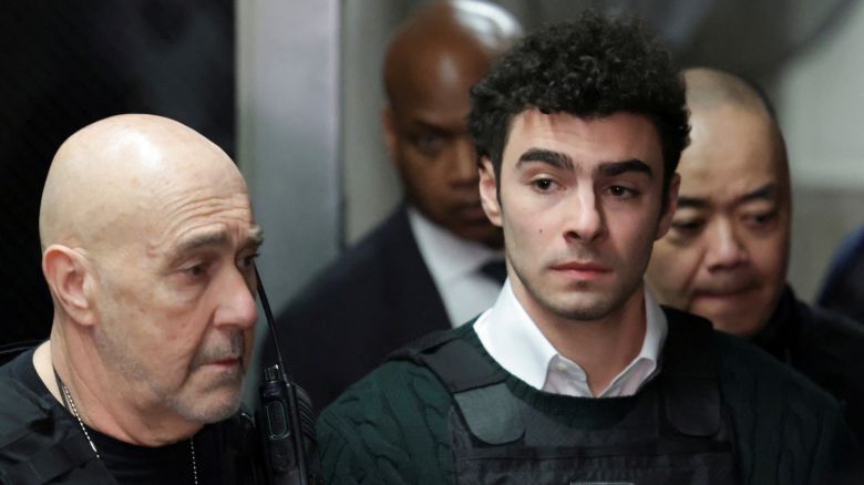 Luigi Mangione, the suspect in the killing of UnitedHealth Group chief executive Brian Thompson, arrives for a hearing in Manhattan Criminal Court on New York state murder and terrorism charges in New York City, U.S., February 21, 2025. REUTERS/Jeenah Moon