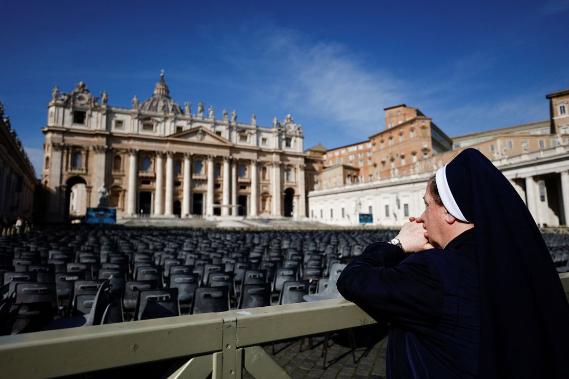 A nun prays in St. Peter’s Square, where Pope Francis would ordinarily lead the Angelus from his window at the Vatican.