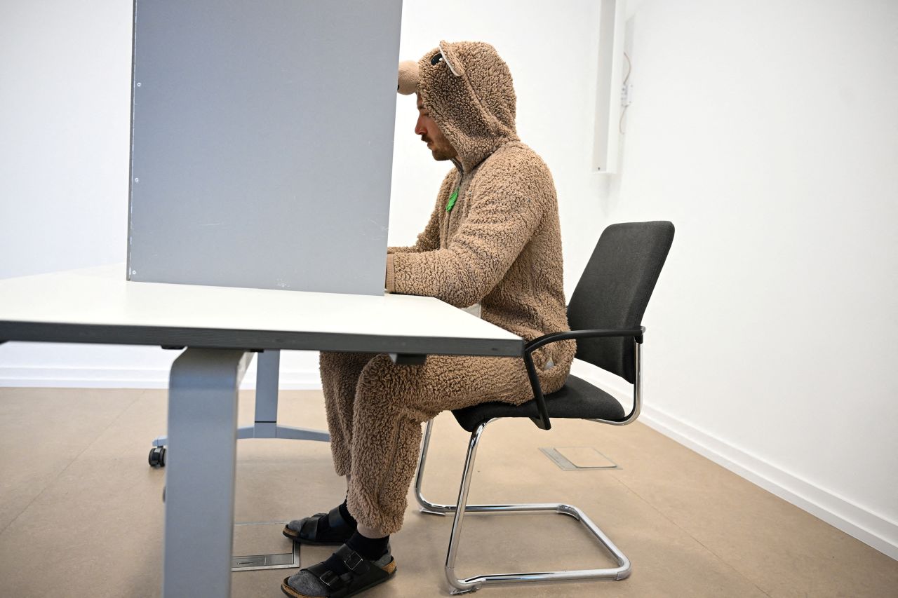 A man wearing a carnival costume votes during the 2025 general election, in Cologne, Germany, February 23, 2025. REUTERS/Jana Rodenbusch TPX IMAGES OF THE DAY