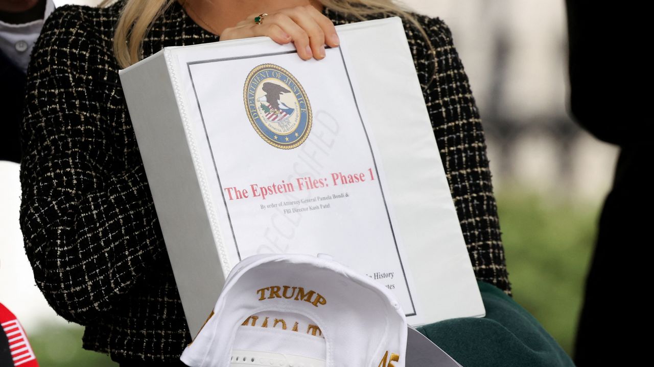 People walk out of the West Wing of the White House with "The Epstein Files: Phase 1" binders on February 27, 2025.