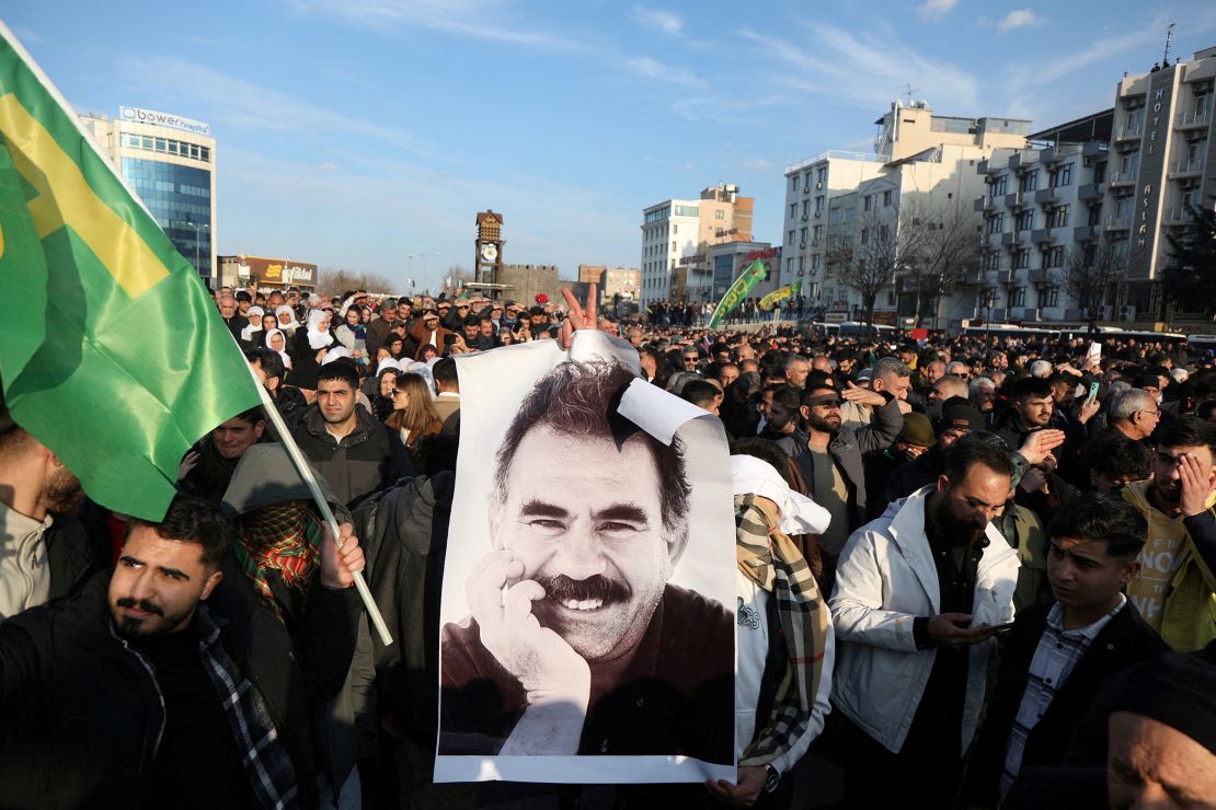 A demonstrator holds a picture of jailed Kurdish militant leader Abdullah Ocalan during a rally in Diyarbakir, Turkey, on February 27, 2025.