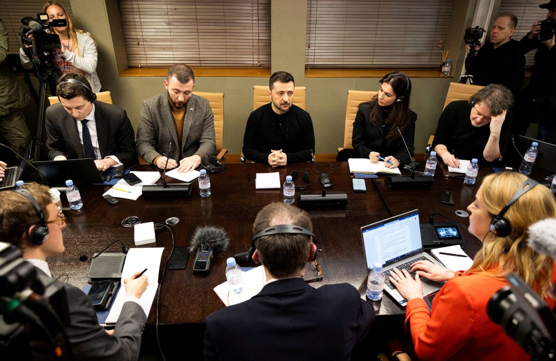 Ukrainian President Volodymyr Zelensky listens to questions during a meeting with journalists on the outskirts of London on Sunday.