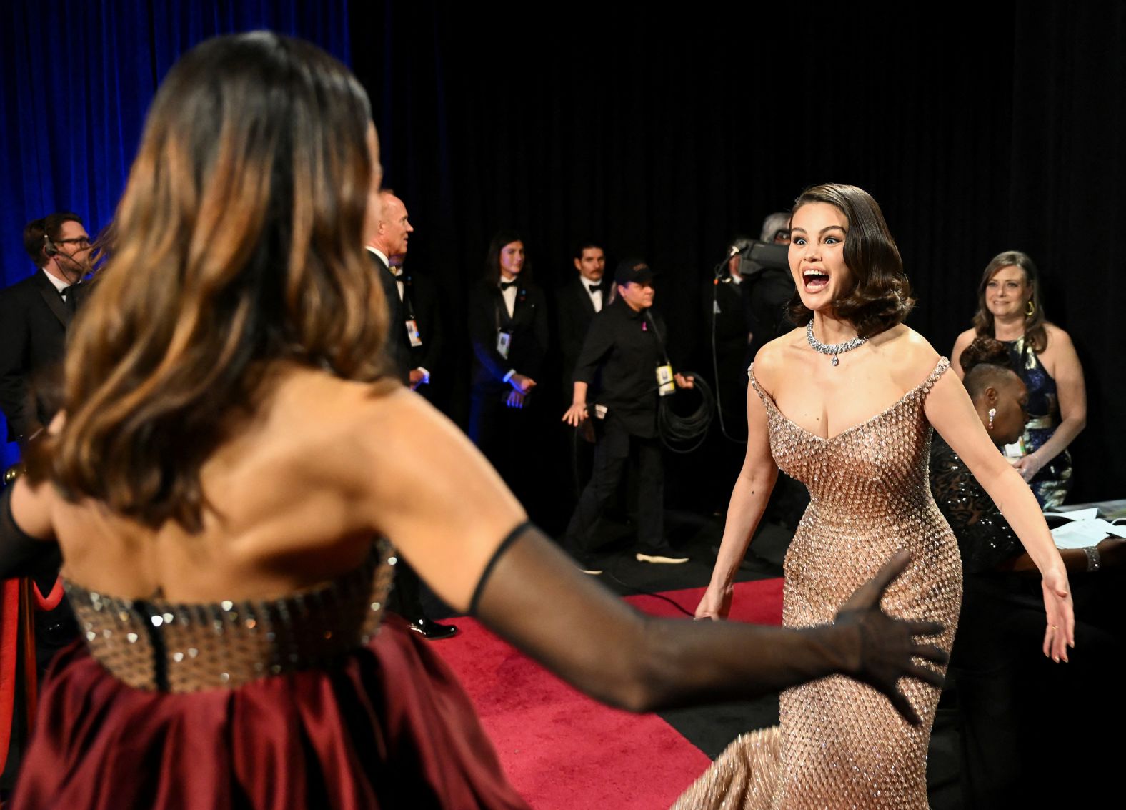 Selena Gomez, right, and Saldaña see each other backstage. Saldaña won the Oscar for best supporting actress.