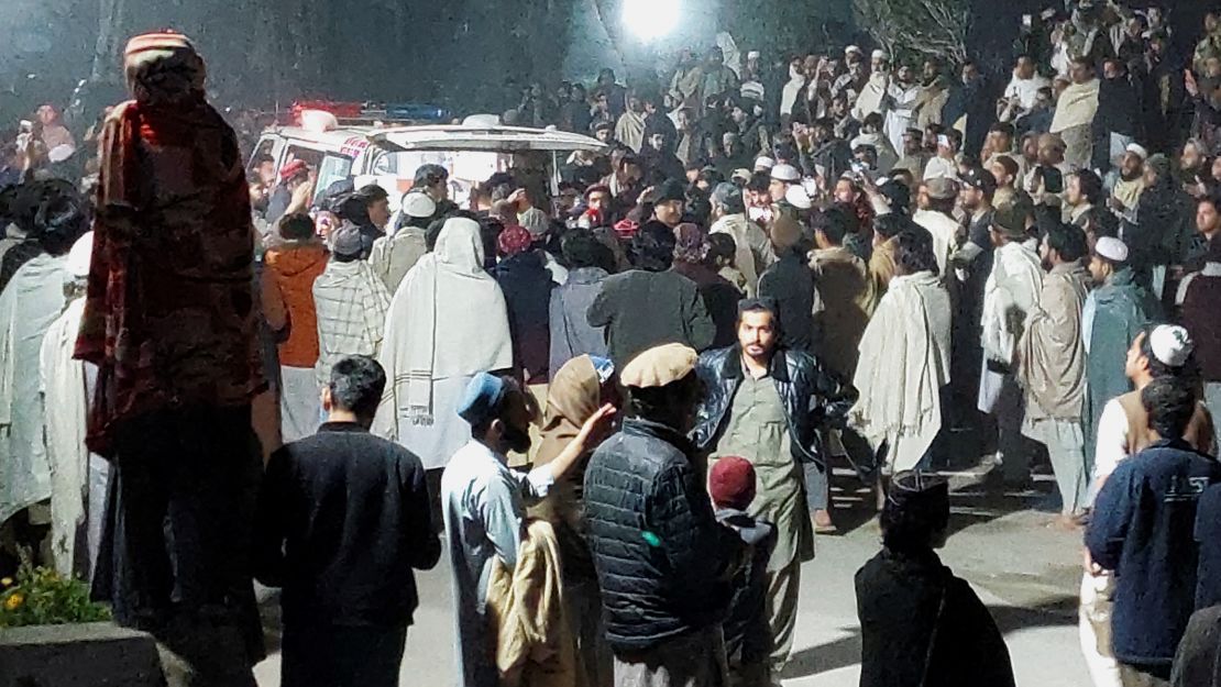 People gather near an ambulance outside a hospital after a suicide bombing in Bannu, Pakistan on March 4, 2025.