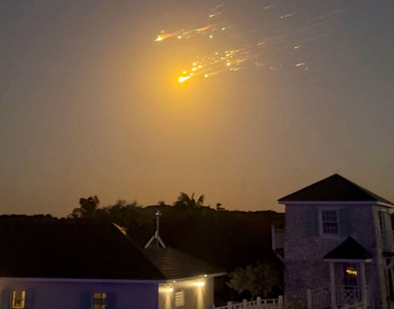 A view shows debris streaking through the sky in Big Sampson Kay, Bahamas, after SpaceX's Starship spacecraft tumbled and exploded during a test flight on Thursday.