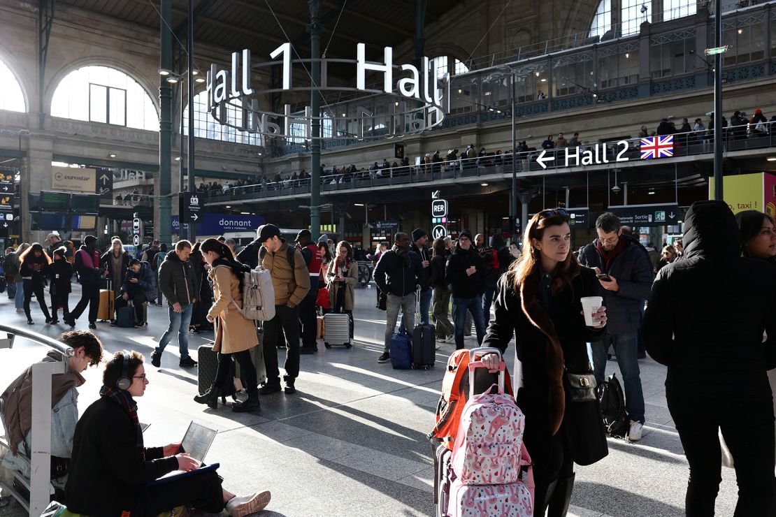 Passengers wait inside the departure hall at Gare du Nord on Friday.