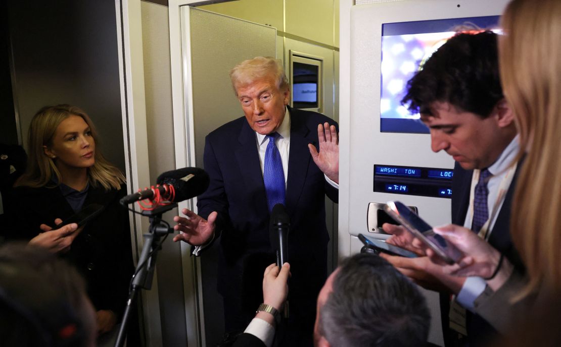 US President Donald Trump speaks to a reporter who rode in Air Force 1 when he returned to Washington, D.C. on March 9, 2025.