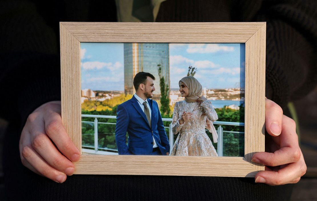 Noor Abdalla, wife of Mahmoud Khalil, holds a photograph of their wedding day.