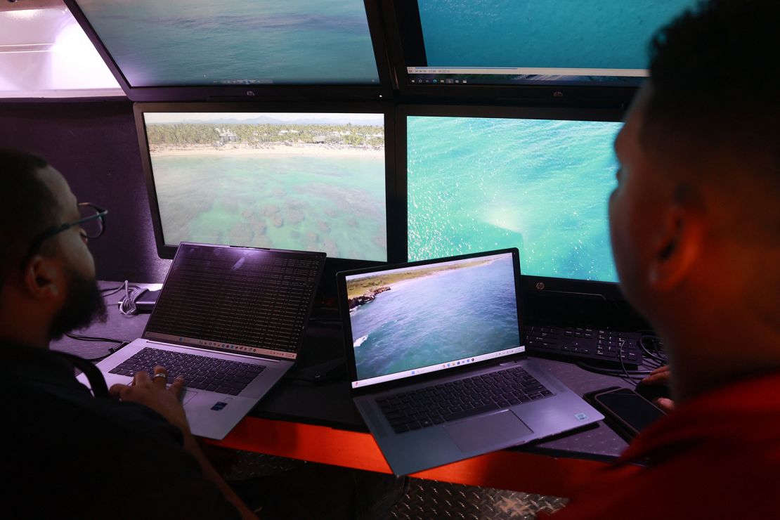 Members of the Armed Forces of the Dominican Republic observe images transmitted by drones as part of the search operation for Konanki, as officials investigate her disappearance as a drowning.