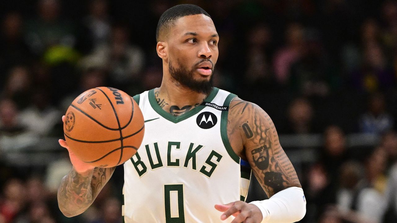 Mar 13, 2025; Milwaukee, Wisconsin, USA; Milwaukee Bucks guard Damian Lillard (0) dribbles the ball against the Los Angeles Lakers in the first quarter at Fiserv Forum. The Bucks wore a small patch to honor former player Junior Bridgeman who passed away this week.  Mandatory Credit: Benny Sieu-Imagn Images