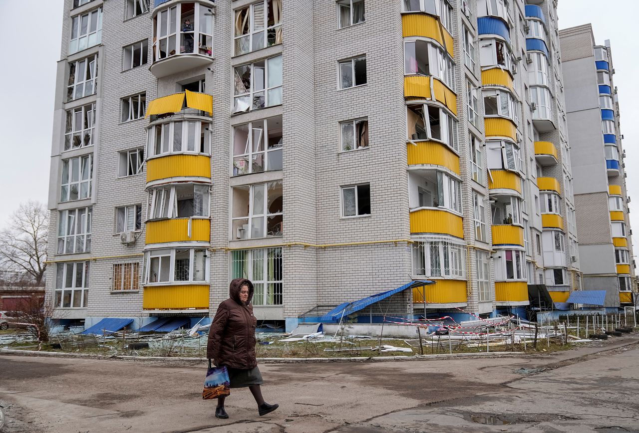 A resident walks near an apartment building hit by a Russian drone strike, in Chernihiv, Ukraine, on Saturday.