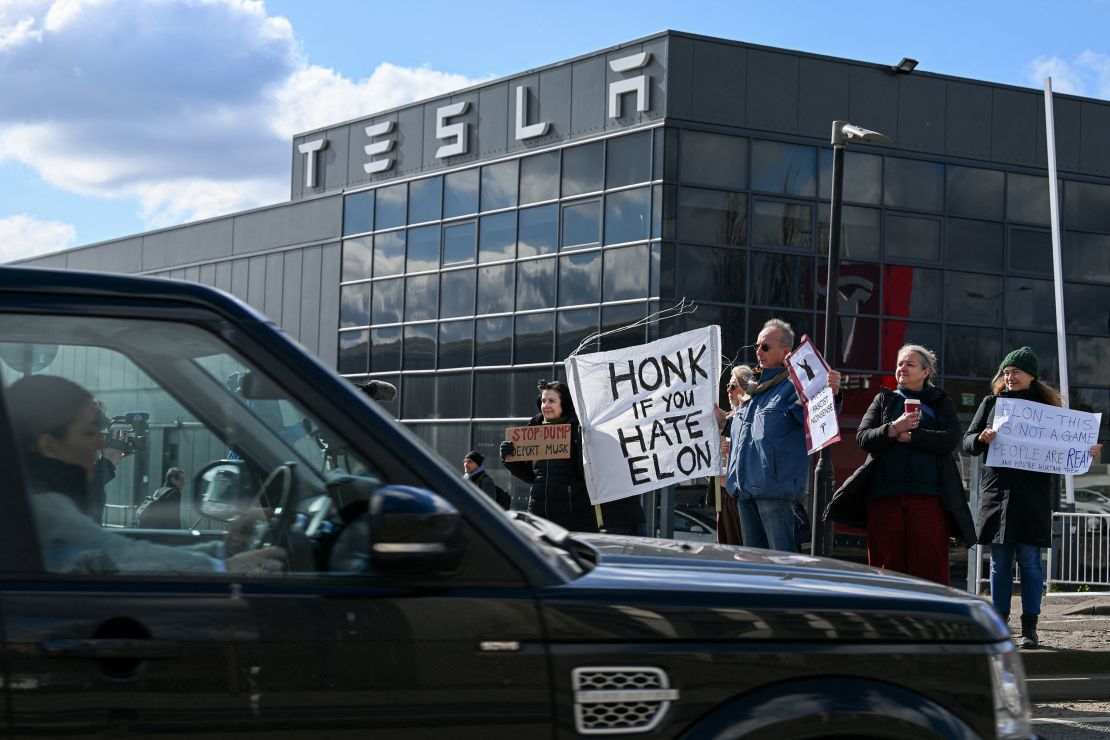 Demonstrators hold anti-Tesla posters during a protest encouraging people to boycott Tesla in opposition to Tesla CEO Elon Musk's political involvement in the U.S. government, outside the Tesla Centre Park Royal in London, Britain, March 15, 2025.