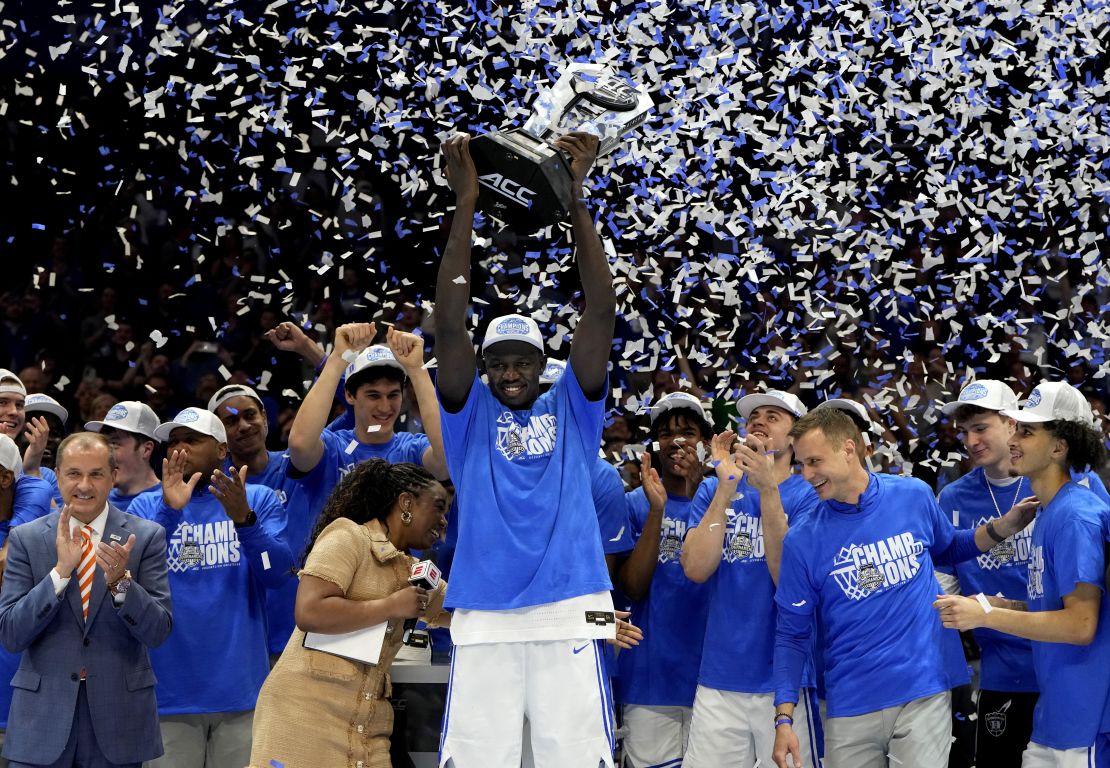 Duke Blue Devils center Khaman Maluach raises the trophy and celebrates with teammates after winning the 2025 ACC Conference Championship.
