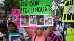 A family member of a Venezuelan deported from the US to El Salvador to be imprisoned in the Terrorism Confinement Center (CECOT) prison, holds a sign that reads "They are not criminals" during a pro-government march to demand their release, in Caracas, Venezuela, on March 18, 2025.