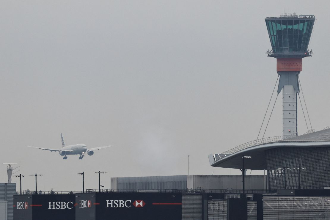 A passenger plane makes its landing approach to Heathrow Airport on Saturday.