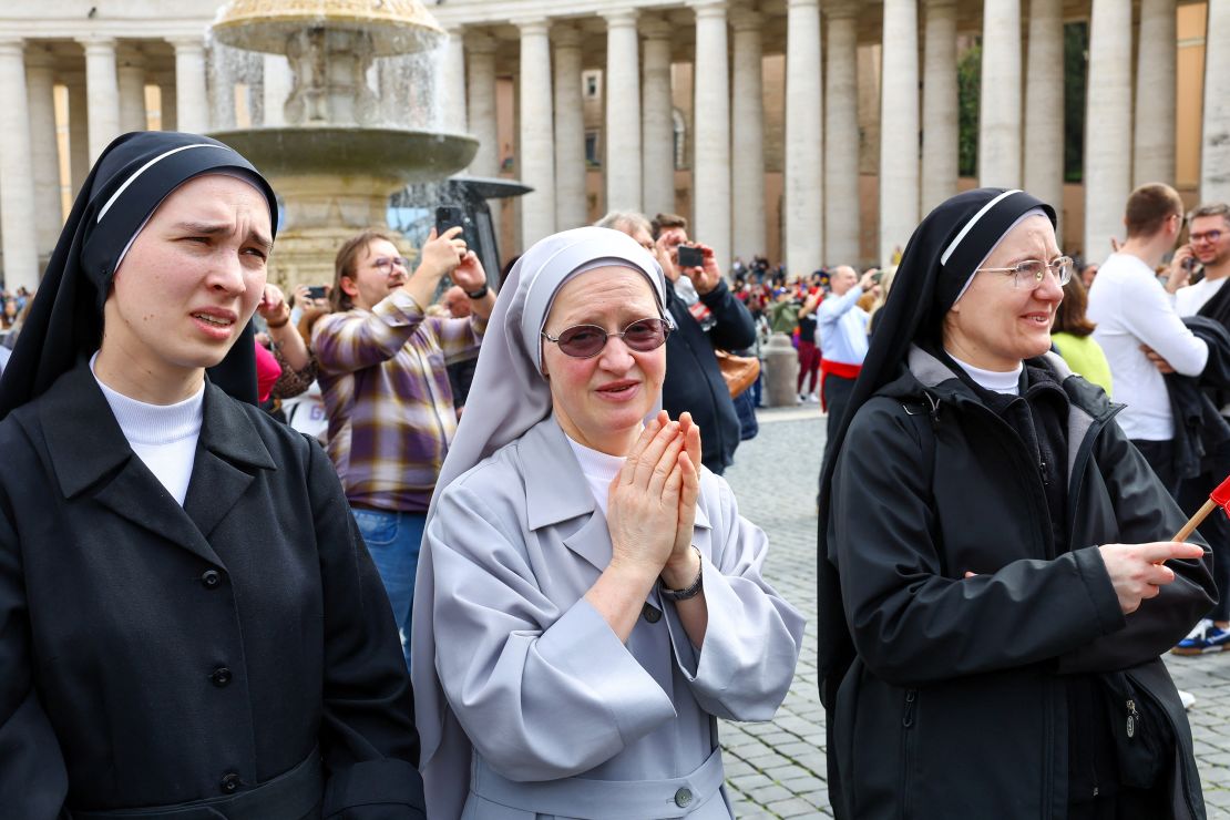 Nuns watch Pope Francis during his first public appearance in five weeks, on a screen in the Vatican's St. Peter's Square.