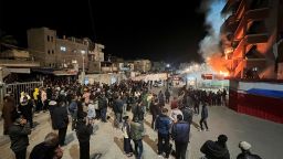 People gather as smoke rises following an Israeli airstrike at Nasser hospital, according to the Palestinian civil defence, in Khan Younis in the southern Gaza Strip March 23, 2025.