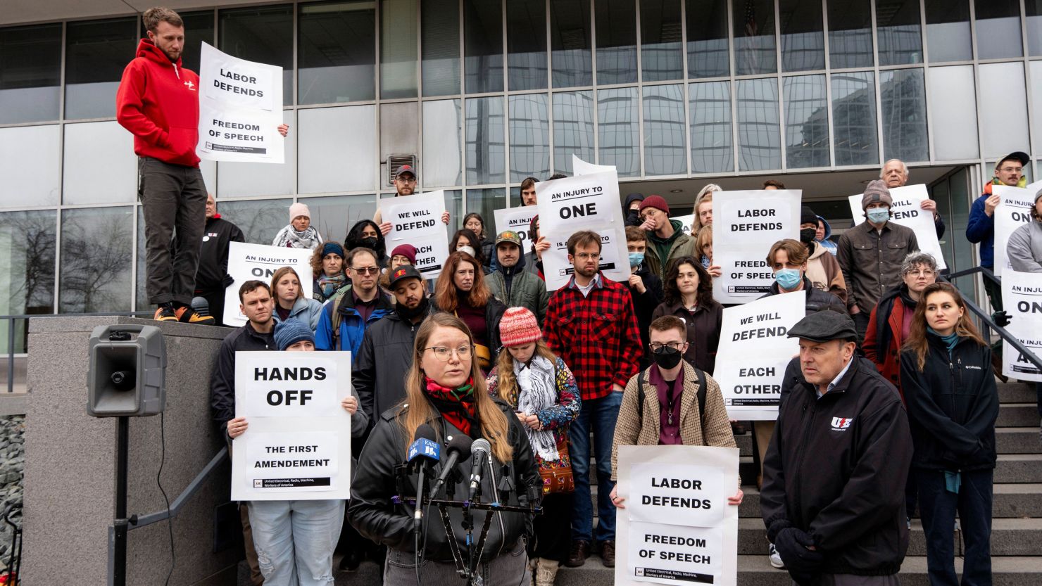 Protestors gather outside the Paul D. Wellstone Federal Building in Minneapolis after a University of Minnesota international graduate student was detained by US Immigration and Customs Enforcement agents.